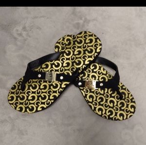 Guess brand black and gold flip - flops